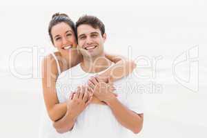 Portrait of young couple embracing each other on the beach