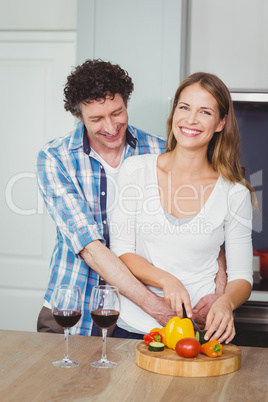Portrait of smiling wife with husband in kitchen