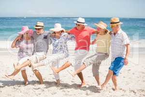 Senior friends dancing on the beach