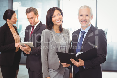 Portrait of happy businesspeople with a file