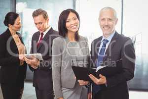 Portrait of happy businesspeople with a file