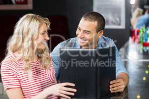 Smiling couple holding menu