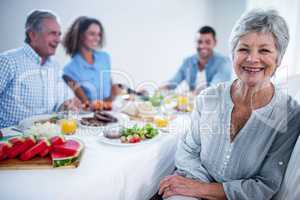 Portrait of senior woman sitting at dinning table