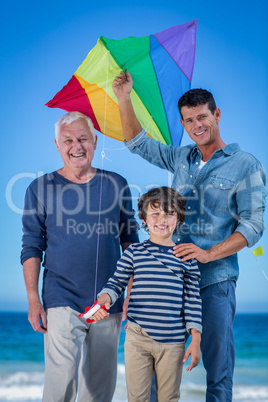 Male family members playing with a kite