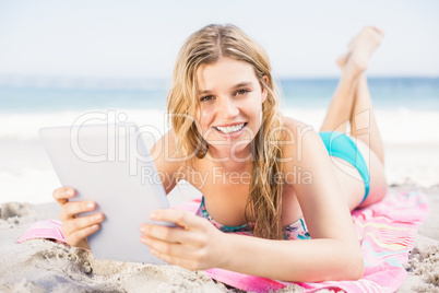 Young woman using digital tablet on the beach