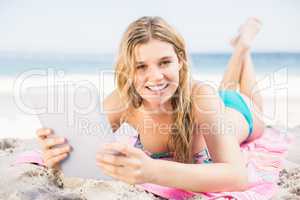 Young woman using digital tablet on the beach