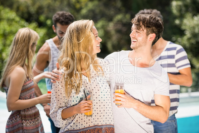 Young couple smiling and having juice together