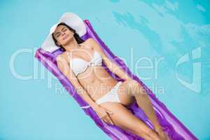 Attractive woman relaxing on inflatable raft