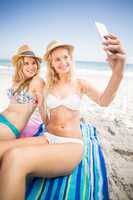 Two friends in bikini taking a selfie