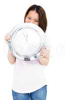 Young woman holding stainless steel clock