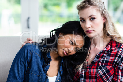 Young woman consoling upset female friend