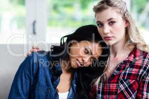 Young woman consoling upset female friend