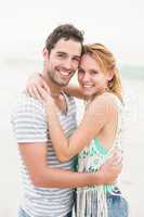 Young couple embracing each other on the beach