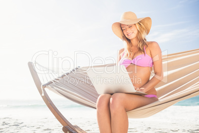 Woman using her laptop in hammock