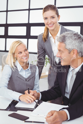 Business people with documents at desk