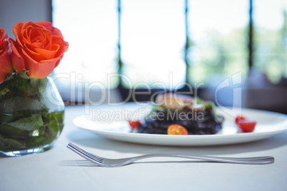 Squid ink spaghetti dish with basil with flowers