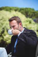 Serious businessman drinking coffee