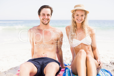 Portrait of young couple sitting on the beach