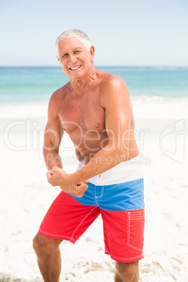 Senior man posing with his muscles