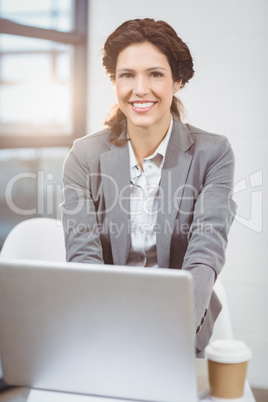 Beautiful businesswoman using laptop in office