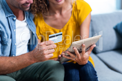 Couple doing online shopping on digital tablet