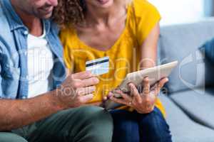 Couple doing online shopping on digital tablet