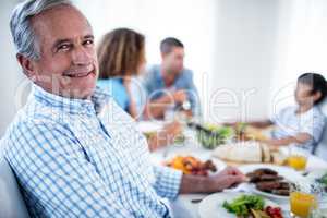 Portrait of senior man sitting at dinning table