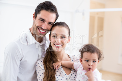 Portrait of smiling parents with baby