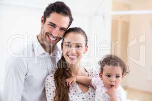 Portrait of smiling parents with baby