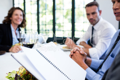 Business colleagues looking at a file and discussing