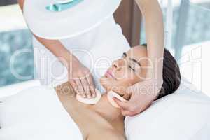 High angle view of woman receiving facial massage