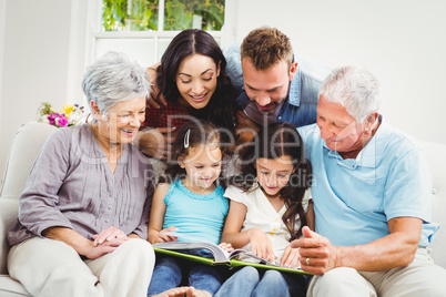 Family assisting girls while reading book