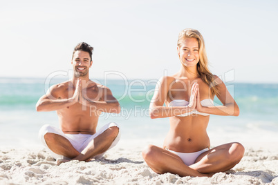 Happy couple doing yoga