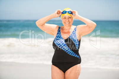 Senior woman with bathing cap at the beach