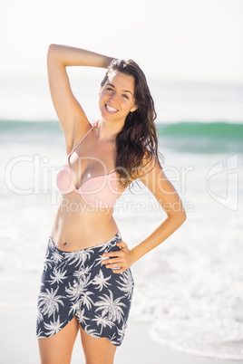 Portrait of pretty woman in bikini standing on the beach