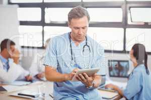 Male doctor using tablet in conference room