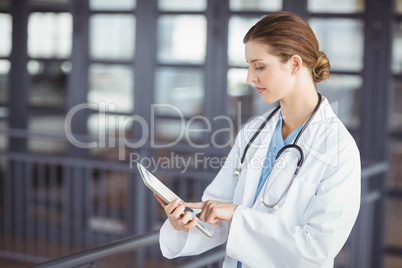 Female doctor holding clipboard while working