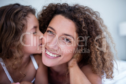Daughter kissing her mother on the cheek