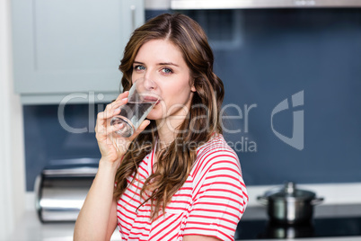 Portrait of beautiful young woman drinking water