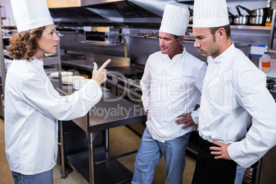 Upset head chef talking to her team