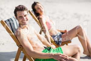 Portrait of young couple sitting on armchair