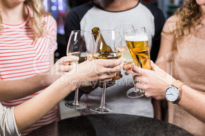 Group of friends toasting with beer and wine