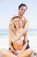 Portrait of young couple embracing on the beach