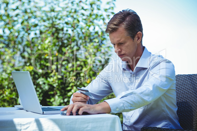 Businessman doing online shopping with laptop and credit card