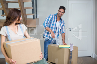 Smiling couple with cardboard box