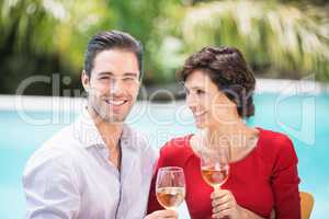 Cheerful couple holding white wine