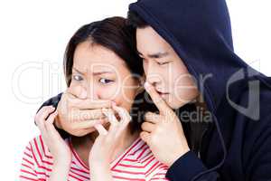Young man covering young womans mouth
