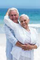 Senior couple embracing at the beach