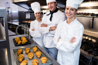 Portrait of three chefs in commercial kitchen