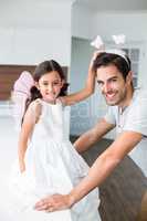 Portrait of smiling father with butterfly headband and daughter